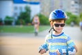 Little boy riding on rollers in the summer in the Park. Happy child in helmet learning to skate. Safety in sport Royalty Free Stock Photo