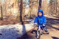 Little boy riding runbike in winter Royalty Free Stock Photo