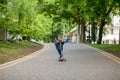 Little boy riding scooter in city park in aummer. Kids sports outdoors. Happy child playing with his scooter. Kid learn to ride Royalty Free Stock Photo