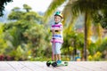Little boy riding scooter. Kids ride kick board Royalty Free Stock Photo