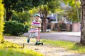 Little boy riding scooter. Kids ride kick board Royalty Free Stock Photo