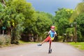 Little boy riding scooter. Kids ride kick board Royalty Free Stock Photo