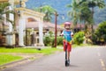 Little boy riding scooter. Kids ride kick board Royalty Free Stock Photo