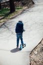 beautiful little boy riding a scooter on the street Royalty Free Stock Photo