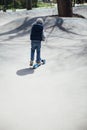 beautiful little boy riding a scooter on the street Royalty Free Stock Photo