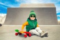 Little boy riding on steep hills to skateboard at the skate Park.Extreme sports. Royalty Free Stock Photo