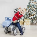 Little boy riding a toy car. Concept Happy Christmas, New Year, Royalty Free Stock Photo