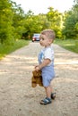 A little boy on a road in the forest. Danger on the road. The child is in danger on the road