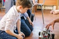 Little boy in robotics school makes robot Royalty Free Stock Photo