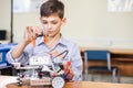 Little boy in robotics school makes robot Royalty Free Stock Photo