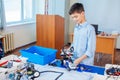 Little boy in robotics school makes robot