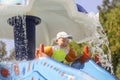 A little boy rolls down a water slide. Children`s joy in the water park. Summer vacation for children in the water park Royalty Free Stock Photo