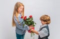 Little Boy with a rose for his teen girlfriend, romantic children. Romantic, boy and girl giving a flower for love and Royalty Free Stock Photo