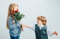 Little Boy with a rose for his teen girlfriend, romantic children, isolated on white background. Little boy giving Royalty Free Stock Photo