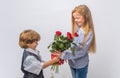 Little Boy with a rose for his teen girlfriend, romantic children. Romantic, boy and girl giving a flower for love and Royalty Free Stock Photo