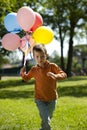 Little boy running with balloons Royalty Free Stock Photo