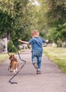 Little boy running with his beagle puppy Royalty Free Stock Photo