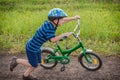 Little boy running with his bike in hands on country road Royalty Free Stock Photo