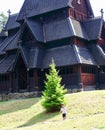 Little boy running and playing in front of the Gol Church, a stave church originally built in Gol city, now in Oslo. Royalty Free Stock Photo