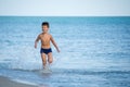 Little boy running at the shore near sea Royalty Free Stock Photo