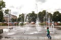 A little boy runs around the fountain in the central square of Uzhhorod on June 13, 2018