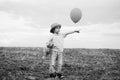 Little boy on the rural road between the colored groung field pointing at a copyspace. The cute boy in the nature Royalty Free Stock Photo