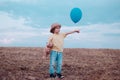 Little boy on the rural road between the colored groung field pointing at a copyspace. The cute boy in the nature Royalty Free Stock Photo