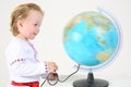 Little boy in russian folk costume looks at big Royalty Free Stock Photo