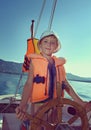 Little boy at sail boat wheel Royalty Free Stock Photo