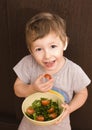 Little boy with salad and tomato Royalty Free Stock Photo