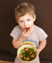 Little boy with salad and tomato Royalty Free Stock Photo