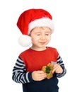 Little boy with Santa hat eating Christmas gingerbread Royalty Free Stock Photo