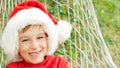 Little boy in santa hat resting on hammock. Christmas family vacation at tropical country. Christmas mood, dreaming, gifts Royalty Free Stock Photo