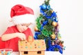 Little boy in Santa's hat building gingerbread