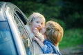 Little boy say good bye with little girl. Bye bye. Cute children saying goodbye before car travel. Good bye before car