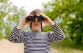 Little boy scanning the woods with binoculars Royalty Free Stock Photo