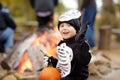 Little boy in scary skeleton costume at halloween celebrations party in forest