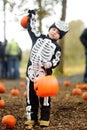 Little boy in scary skeleton costume at halloween celebrations party in forest. Halloween - traditional american holiday