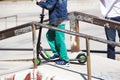 Little boy on scooter board in the ramp of the skate park Royalty Free Stock Photo