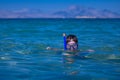 A little boy in a sea with a mask and snorkel Royalty Free Stock Photo
