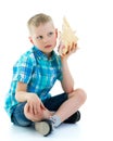 A little boy with a sea shell.The concept of a family vacation a Royalty Free Stock Photo