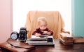 Little boy secretary type paper on old typewriter at desk. Child learn typing on retro typewriter in office