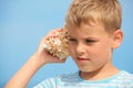 Little boy with shell listening noise of sea Royalty Free Stock Photo