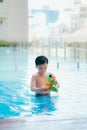 Little boy shooting with water gun in the pool Royalty Free Stock Photo