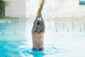 Little boy shooting with water gun in the pool Royalty Free Stock Photo