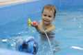 Little boy shooting with water gun in the pool Royalty Free Stock Photo