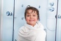 Little boy after shower covered in towel smile