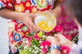 Little boy showering water on older hand Thailand water festival ,Songkran Thai tradition Royalty Free Stock Photo