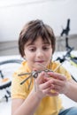 Little boy showing bicycle multi tool on white