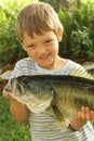 Little boy showing off his fresh catch upclose